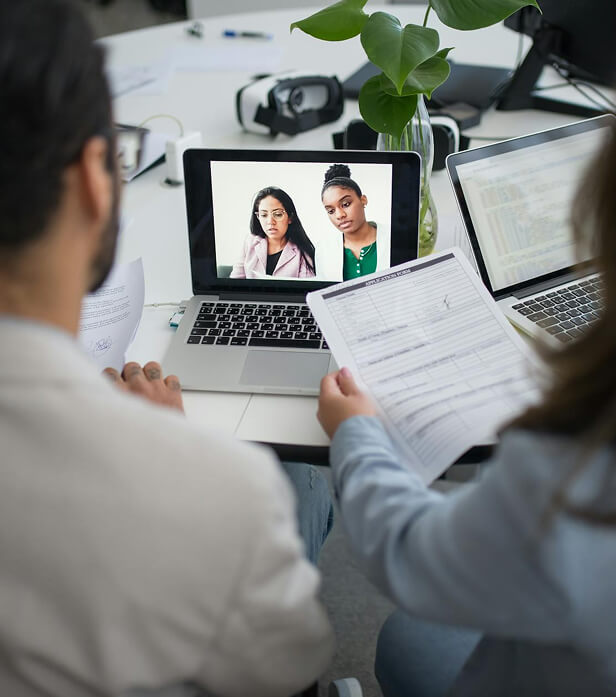 HR virtual meeting; employees on laptop screen.